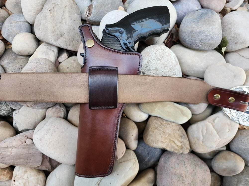 Underside of the Lone Wolf Mcquade belt and holster, the leather is a pale brown with solid brass hardware.