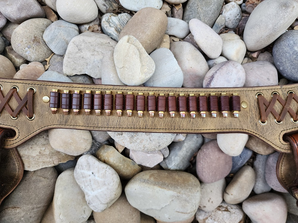 Close up view of buscadero with 18 bullet loops made of brown leather surronded by criss cross lacing.