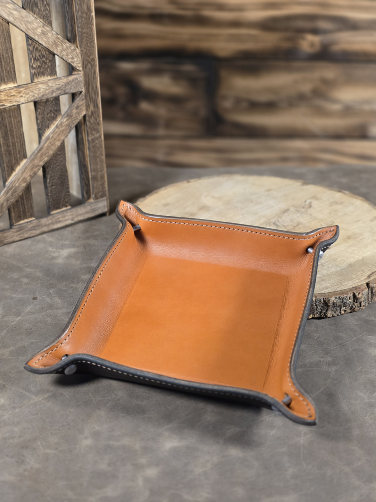 Tan English Bridle leather nightstand tray on a stone surface with wooden background