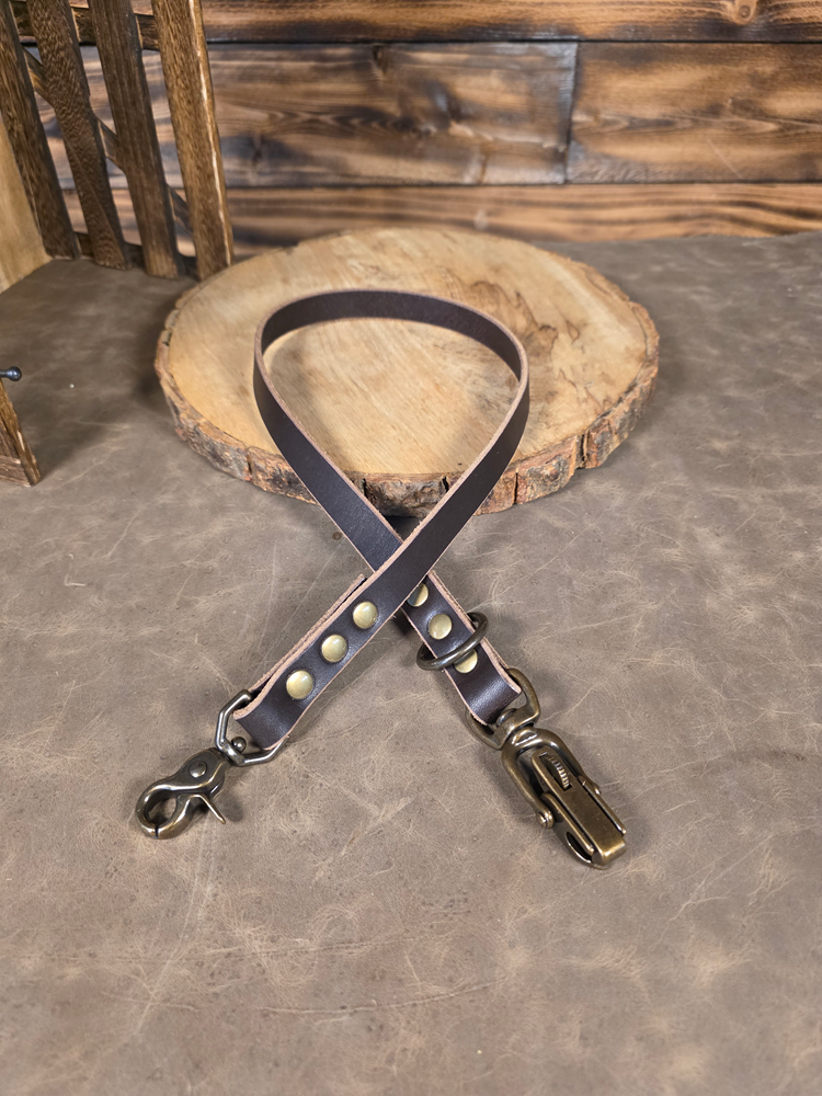 Dark Brown Leather dog leash extension with antique metal hardware on a wooden surface