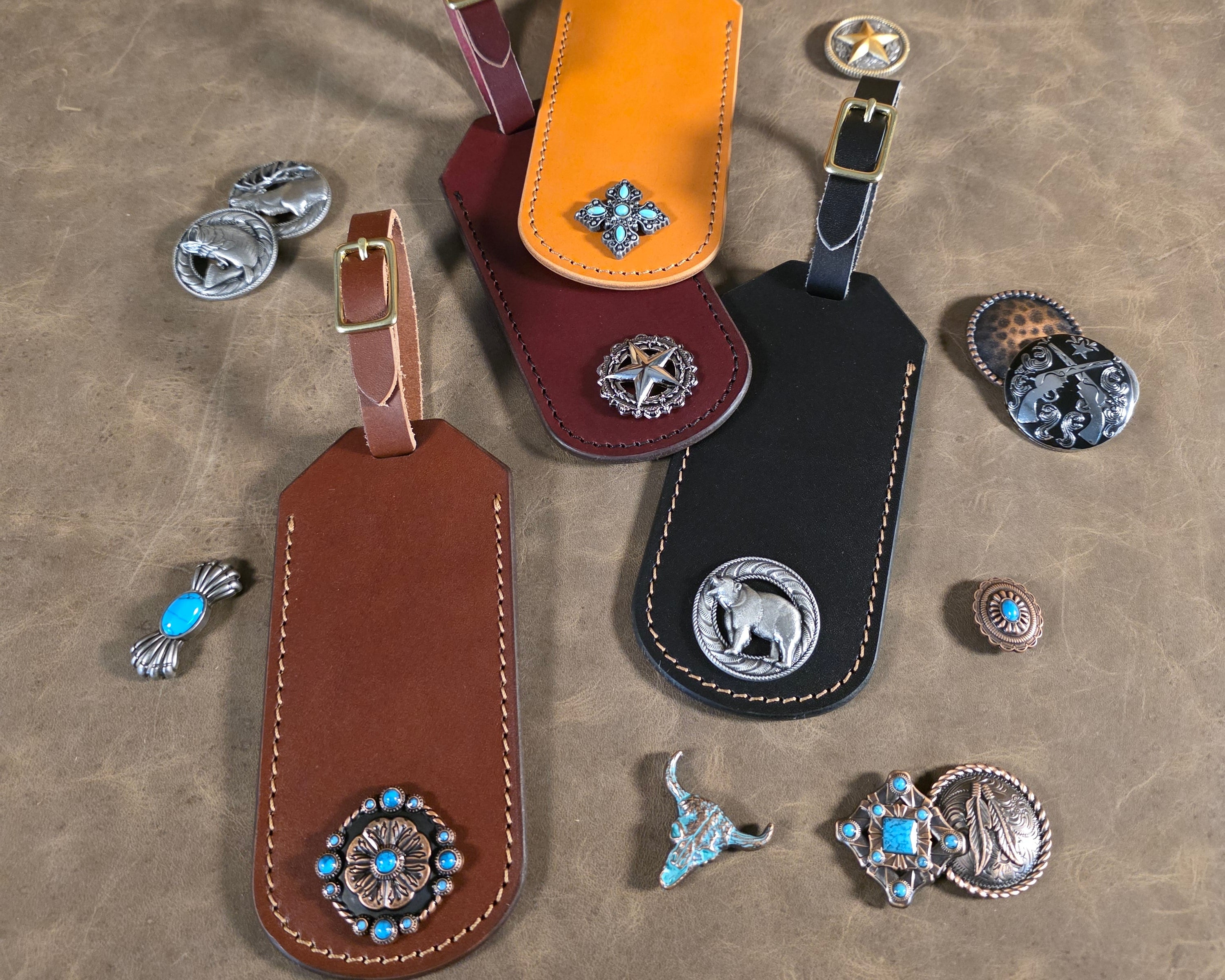 Four beautiful handcrafted English Bridle luggage tags in black, brown, tan and oxblood with a variety of conchos and medallions.