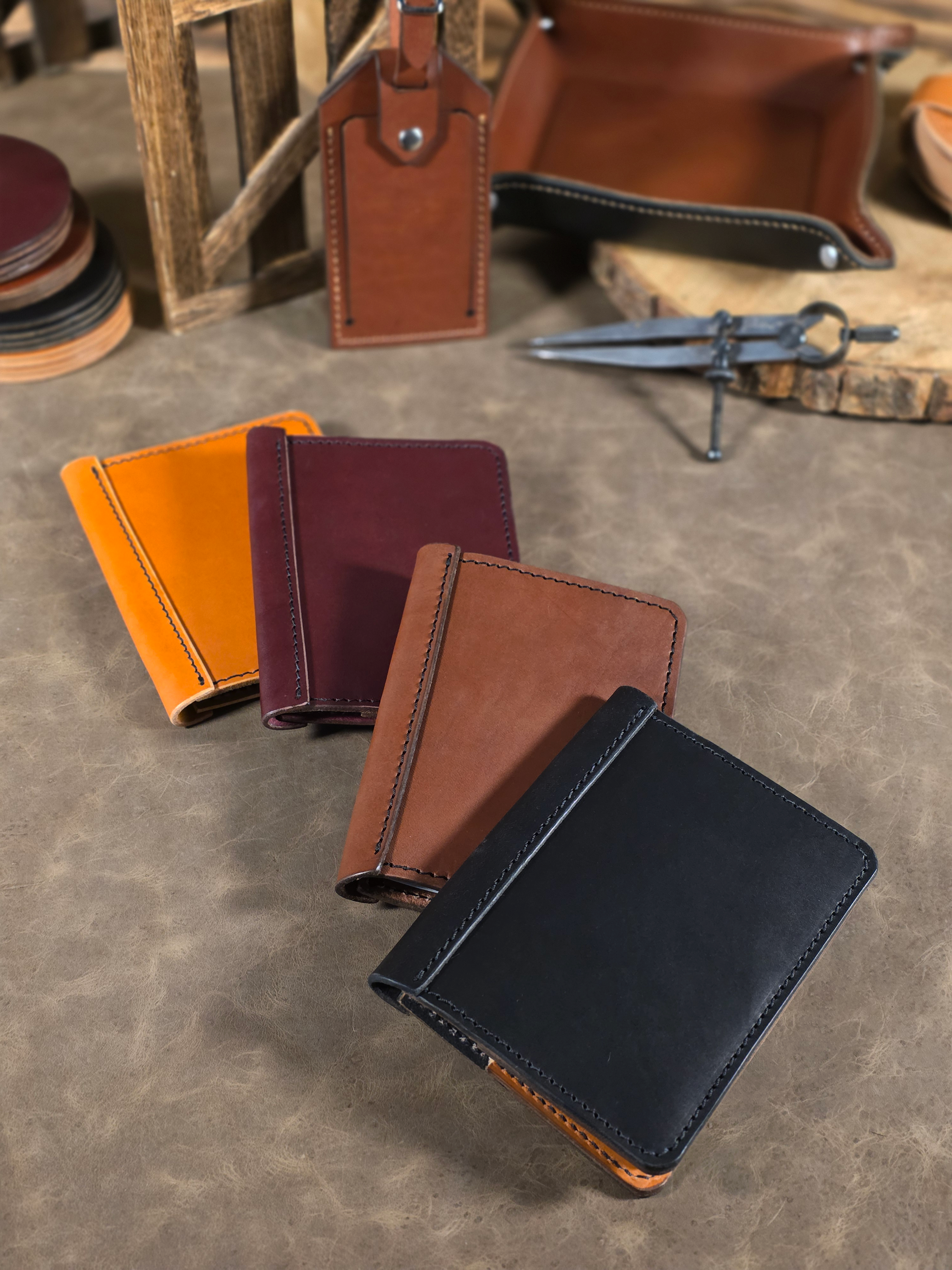 A spread of leather passport wallets in various colors on a textured surface.
