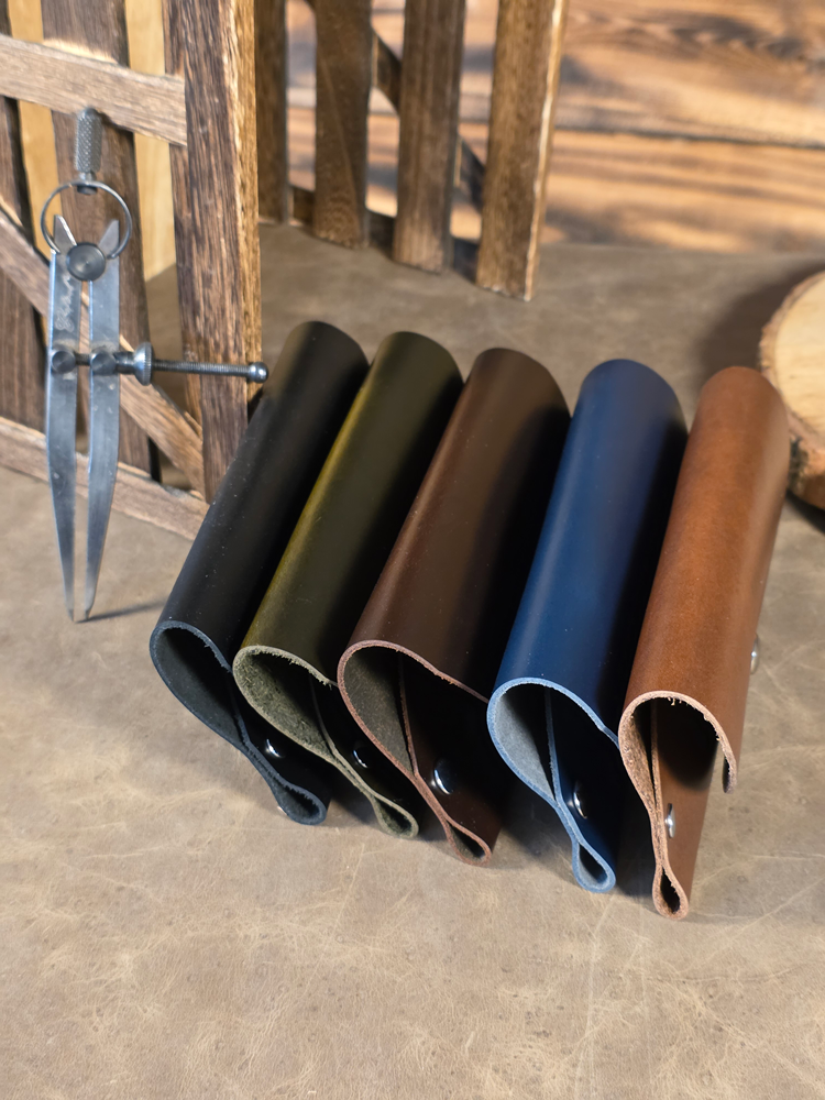 Five Balmoral Leather sunglass cases in a line, in multiple colors
