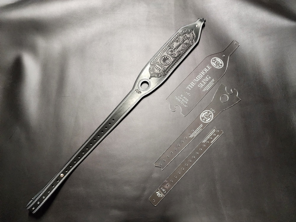 black leather sling on a black surface, laying next to the acrylic pattern