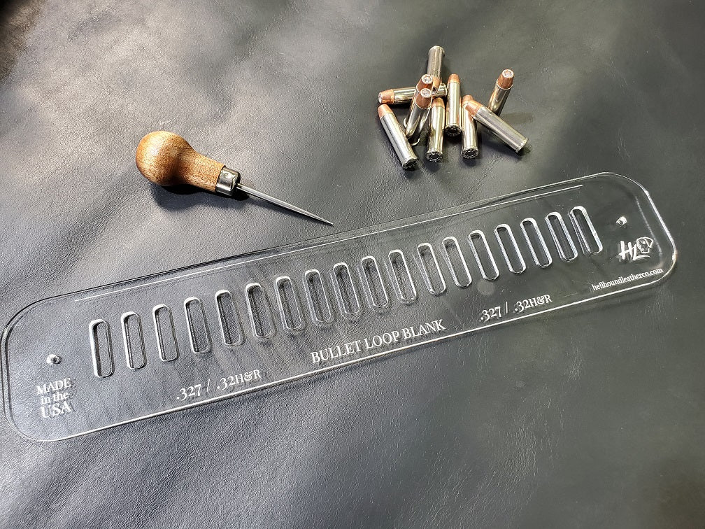 An acrylic bullet loop pattern used in leathercraft to mark the spacing between bullet loops on a western gun belt sits next to a pile of .32HR bullets.