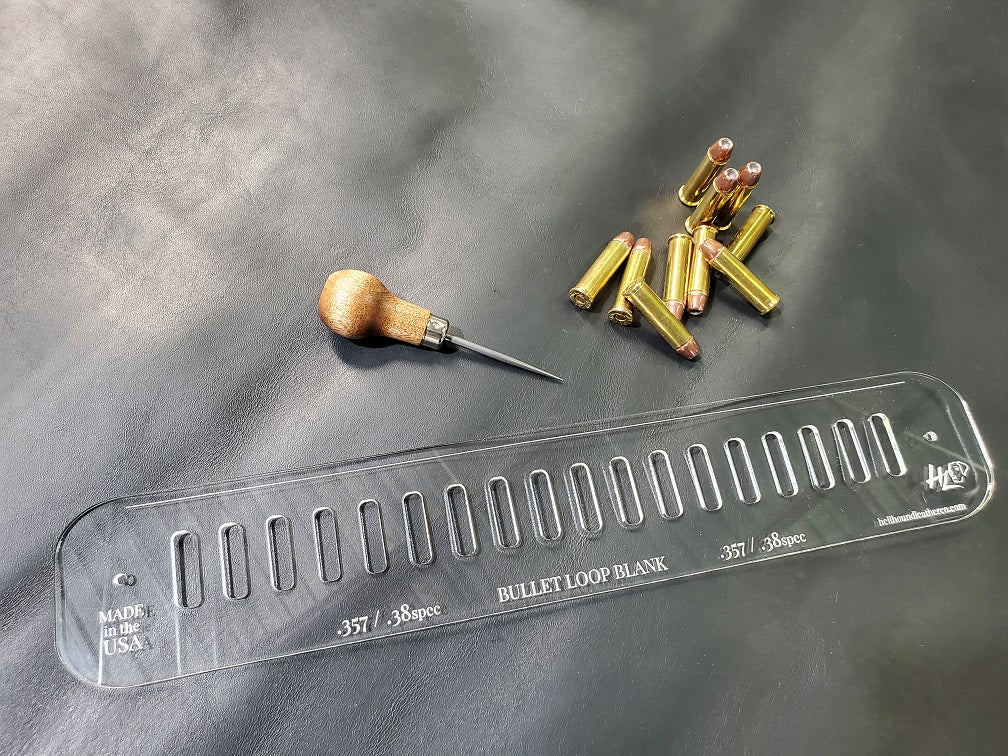 An acrylic bullet loop pattern used in leathercraft to mark the spacing between bullet loops on a western gun belt sits next to a pile of .357 magnum bullets.