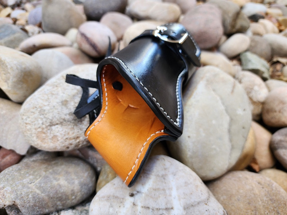 Russet leather interior on a black leather holster with white stitching.