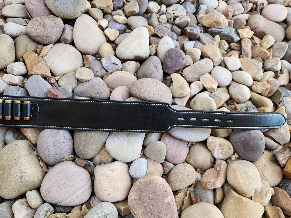 Image showcasing the billet end of the Angel Eyes gun rig, the gun rig lays of a bed of pale river rocks.