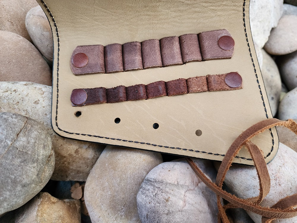 Interior of a brown leather buttstock cuff with tan interior leather.
