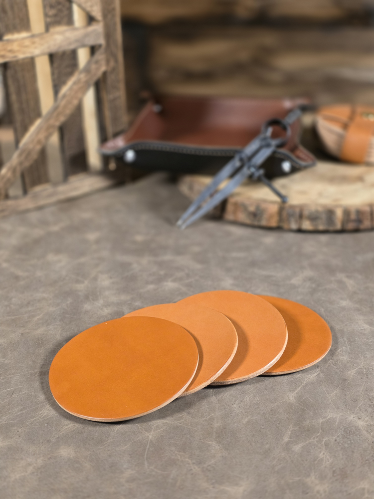Set of russet leather coasters on a stone surface with rustic background