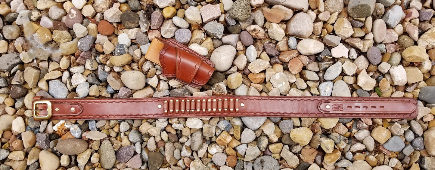 Brown western ranger gunbelt and holster stretched across multicolored rocks