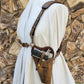 Rustic WWII Tanker shoulder holster on a canvas draped mannequin over a jagged brown rock background.