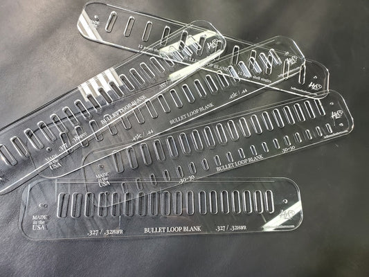 A pile of acrylic template patterns used to mark bullet loops in western gun belts sits atop a gray background.