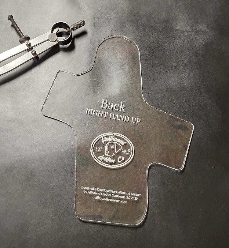 Back piece of the 1911 holster pattern sitting on a black leather holster.