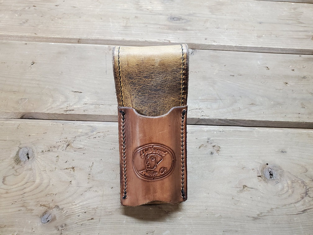 Back view of a distressed brown leather mag pouch.