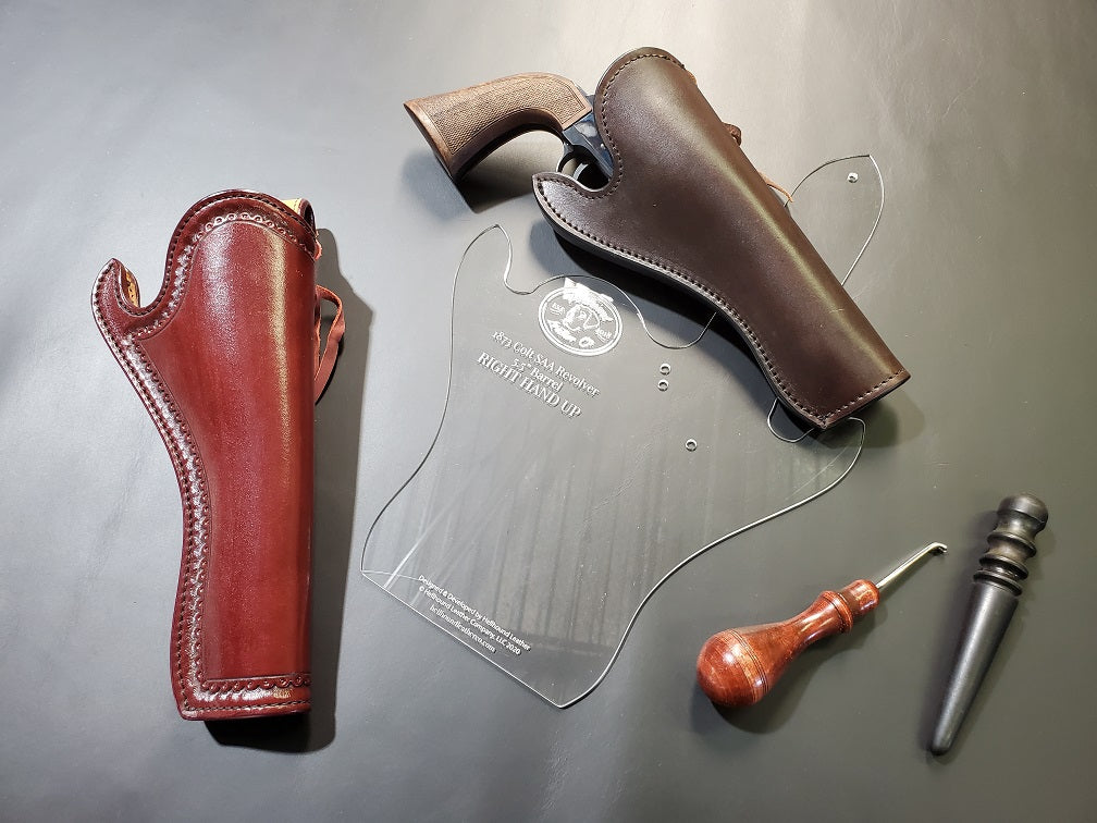 Western style slim leather holsters sit atop an acrylic template of the same in a gray background.