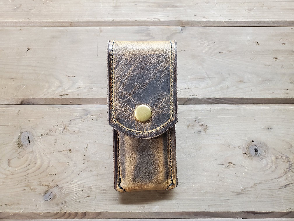 distressed brown M1911 mag pouch featuring solid brass hardware.